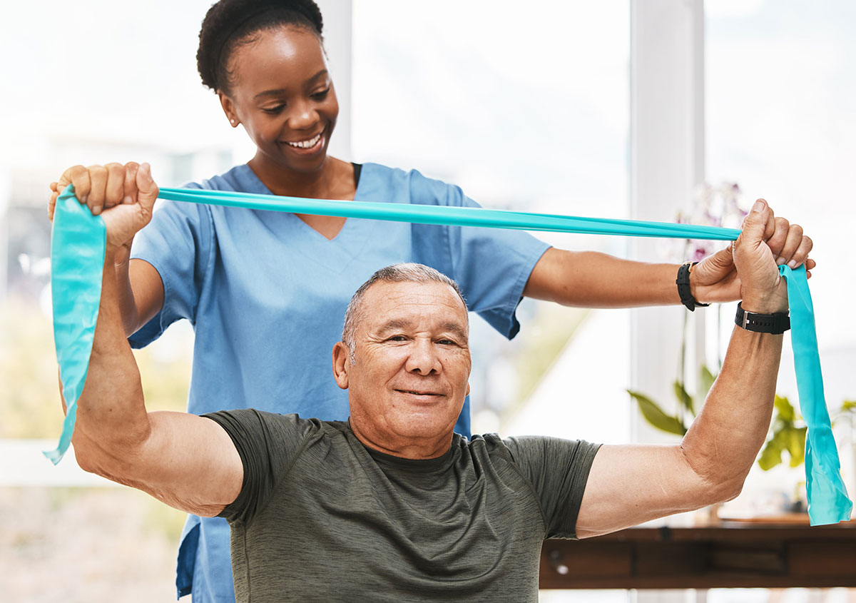 A nurse helping a man exersize