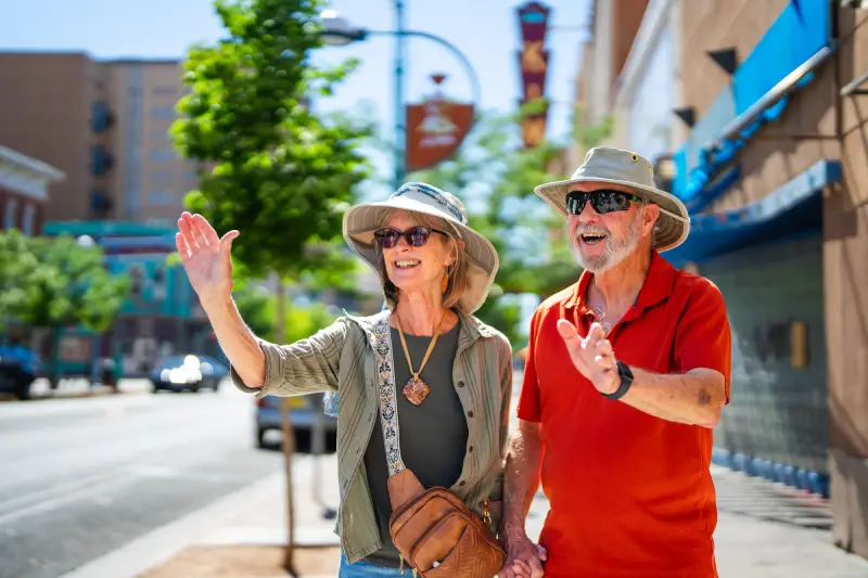 Couple waving goodbye to friends