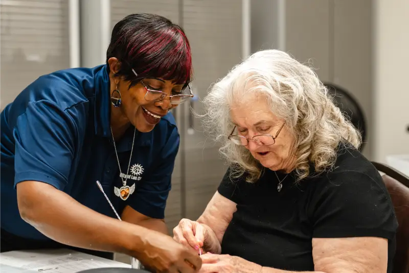 Nurse helping elderly woman