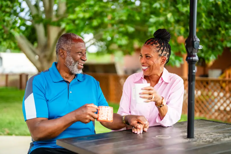Couple having morning coffee outside