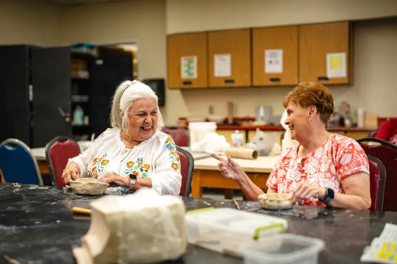 Two friends at a pottery class