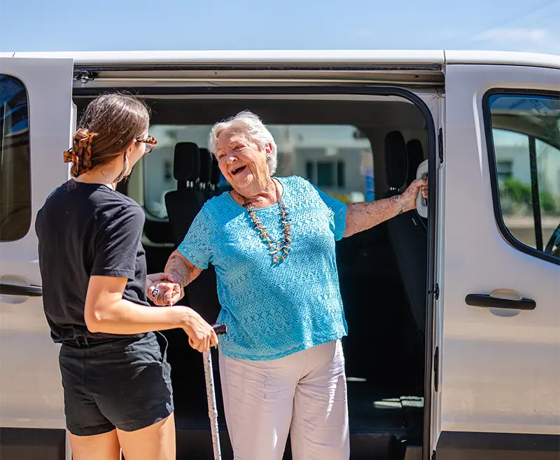 Two elderly people talking to a resource center staff person