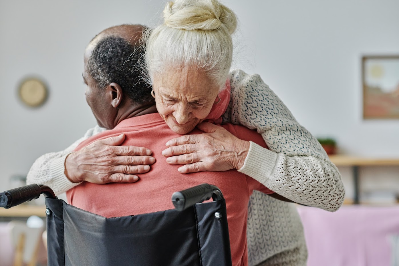 Woman hugging a man in a wheel chair