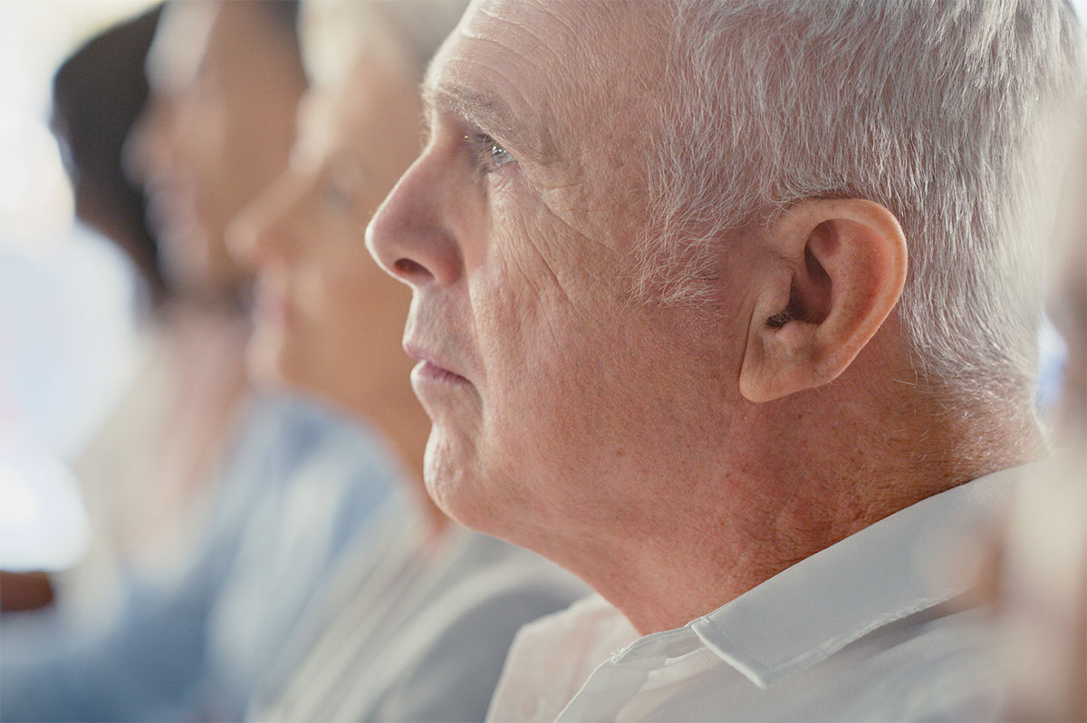 A-row-of-persons-engaged-in-listening-at-a-conference-on-older-adults A row of persons engaged in listening at a conference on older adults