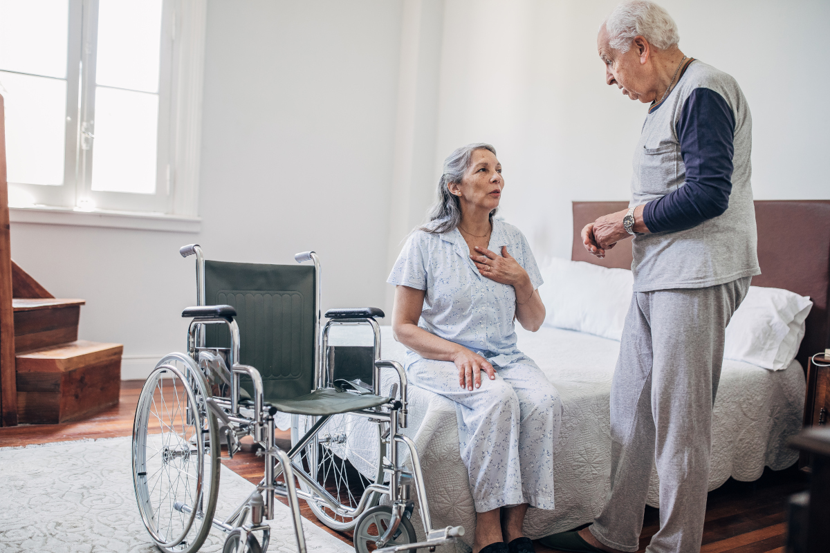 Man talking to woman with wheelchair