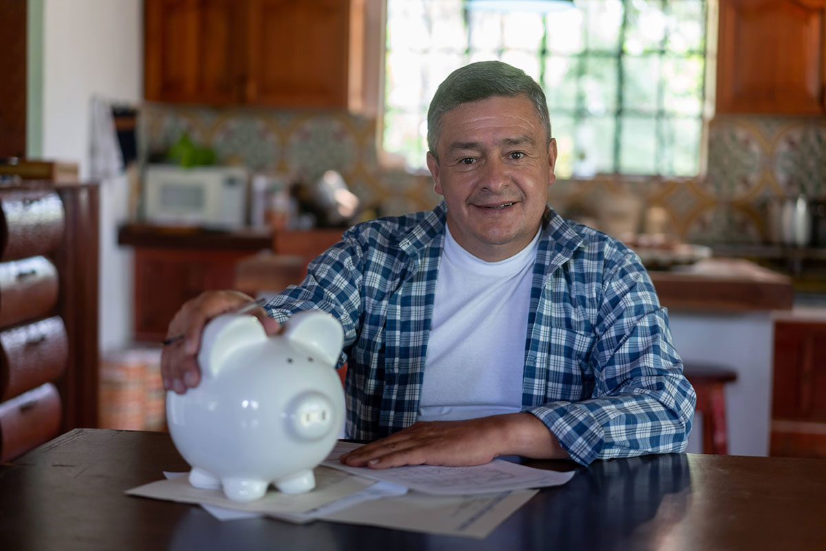 Man protecting his piggy bank