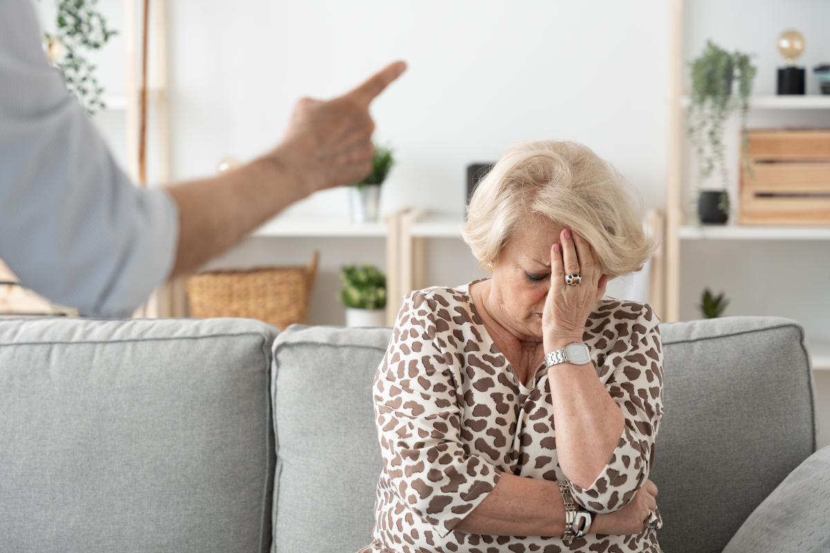 An angrey man scolding an older woman