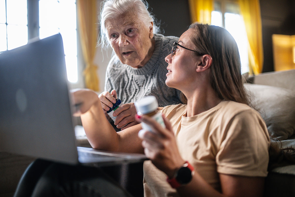 an older woman and young family member receive online prescription counseling