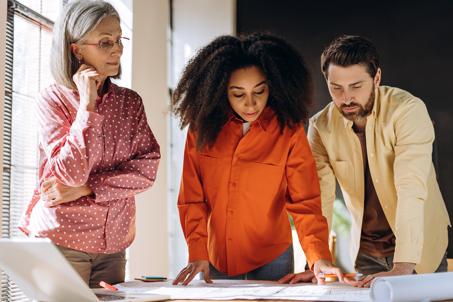 Architects examining blueprints in the office